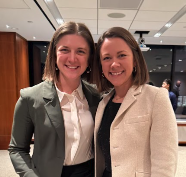 Two-women-posing-together-in-professional-attire.