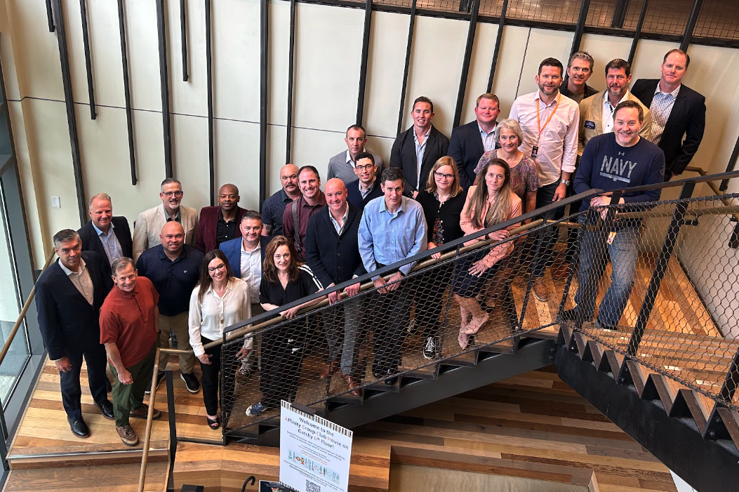 Group photo of people standing on a staircase at a business event