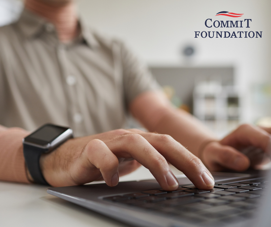 a guy typing on a laptop